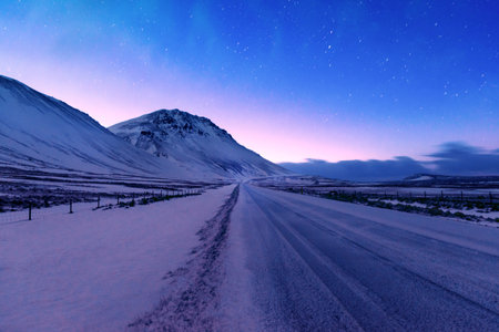 Iceland road trip, the highway along mountains covered with snow, amazing Icelandic landscape,...
