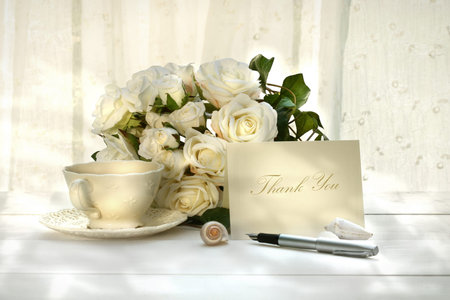 Writing invitation card with pen and a cup of tea