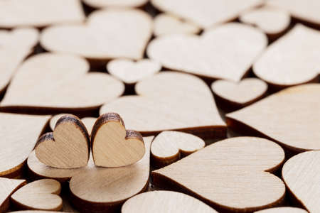 Many wooden colorless hearts background, two special ones true love conceptの写真素材