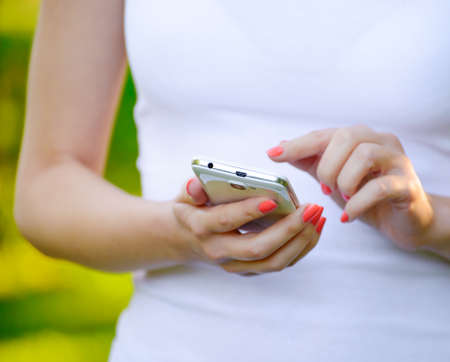 Woman Using her Mobile Smart Phone Outdoorsの写真素材