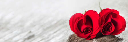 Hearts of red roses on wooden background Valentines day designの写真素材