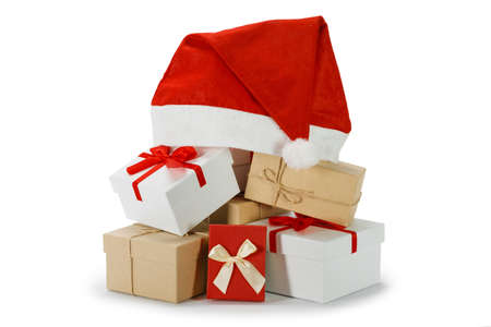 Heap of many Christmas gifts and santa hat isolated on white backgroundの写真素材
