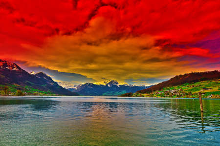 Lake Sarner on the Background of Snow-capped Alps in Switzerland at Sunsetの写真素材