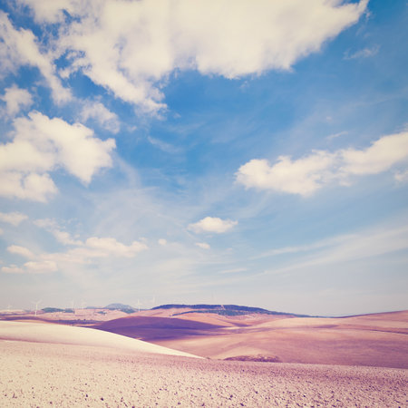 Plowed Fields on the Background of the Modern Wind Turbines Producing Energy in Spainの写真素材
