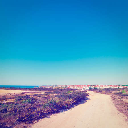 The Dirt Road Leading to the City on the Atlantic Coast of Portugalの写真素材