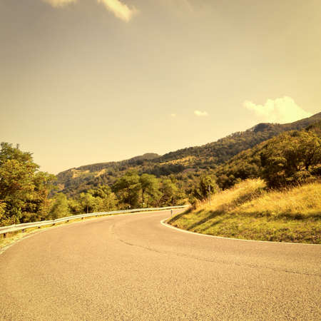 Winding Paved Road in the Italian Alps, Vintage Style Toned Pictureの写真素材