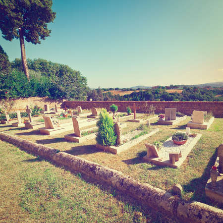 Churchyard on the Background of the Tuscan Landscape at Sunset, Vintage Style Toned Pictureの写真素材