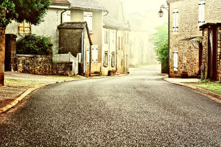 French Village Street in the Morning Mist, Vintage Style Toned Pictureの写真素材