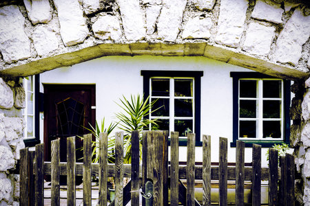 Entrance of the building in Austria, decorated with plants and wooden fence. Traditional Austrian...