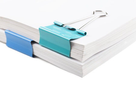 Closeup view of blue metal clips on white paperの写真素材