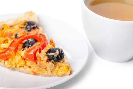 A slice of pizza on a plate and a cup of teaの写真素材