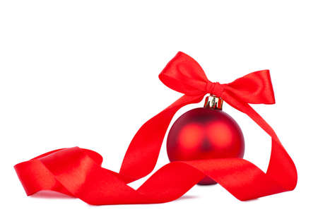 Red christmas decoration with red bow over white backgroundの写真素材