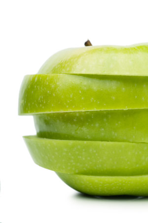 Sections of fresh ripe green apple isolated over white background. Diet conceptの写真素材