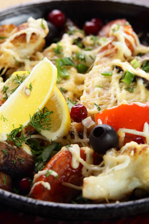 roasted meat with pepper on black pan