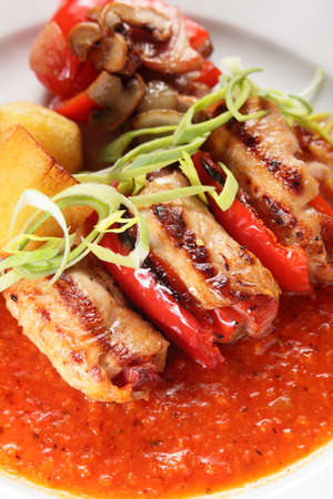 hot and tasty peaces of meat with garnishの写真素材