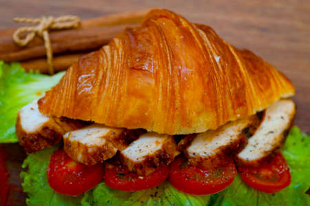 savory croissant brioche bread with chicken breast and vegetable rustic styleの写真素材