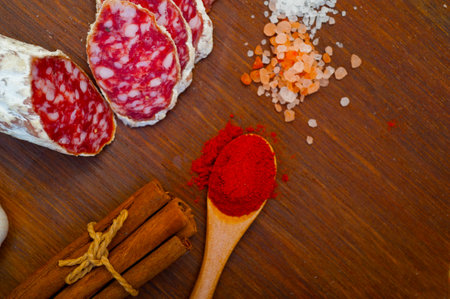 traditional Italian salame cured sausage sliced on a wood boardの写真素材