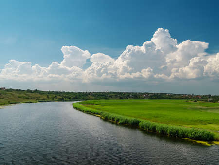 white clouds over riverの写真素材