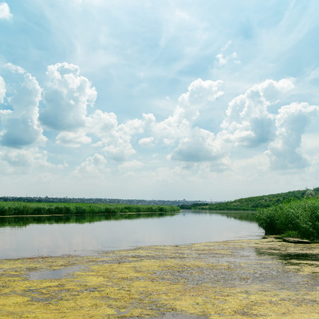 clouds in blue sky over river
