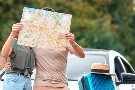Closeup family of two with map travel by car