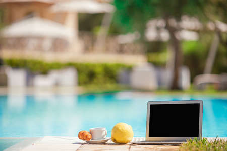 Delicious breakfast lemon, coffee, croissant by the poolの写真素材