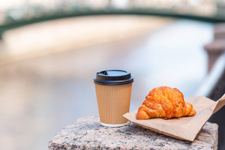 Traditional breakfast of coffee and fresh croissant outdoorsの写真素材