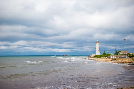 White lighthouse in a bay at seaの写真素材