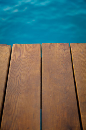 Closeup view of wooden pier with blue sea backdropの写真素材
