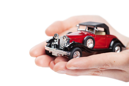 Closeup view of toy car in woman hands isolated over white backgroundの写真素材