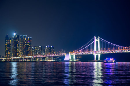 Gwangan Bridge and skyscrapers illuminated in the night. Busan, South Korea