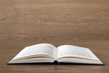 Open book on wood background