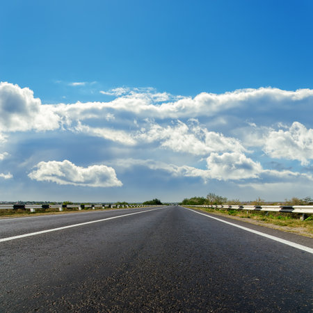 asphalt road to cloudy horizonの写真素材