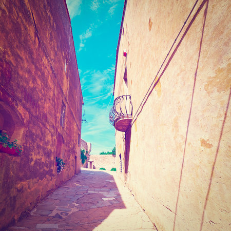 Narrow Street with Old Buildings in Italian Cityの写真素材