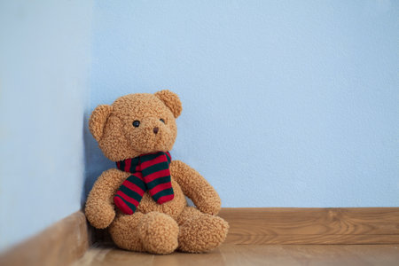 Single teddy bear on a floor in a child roomの写真素材