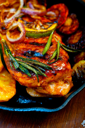 roasted grilled BBQ chicken breast with herbs and spices rustic style on iron skilletの写真素材