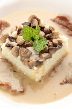 hot roasted meat with rice and mushrooms on white backgroundの写真素材