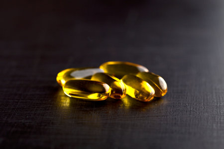 Omega-3 oil capsules and vitamin for health care on black board background. Healthy lifestyle...