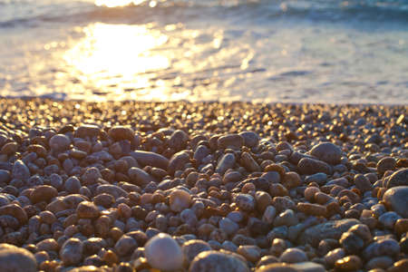 Beautiful seascape, amazing view of pebble coastline in mild sunset light, romantic evening on the beach.の写真素材