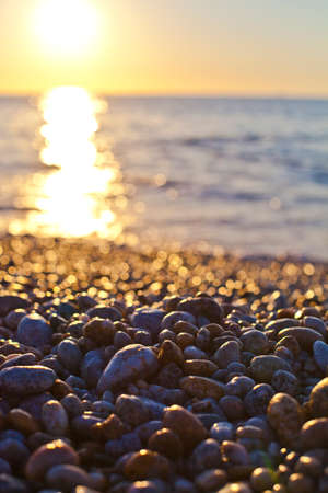 Beautiful seascape, amazing view of pebble coastline in mild sunset light, romantic evening on the beach.の写真素材