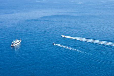 View of boats sailing across the blue clear waters of Adriatic Sea. Tremiti Islands, Italy.