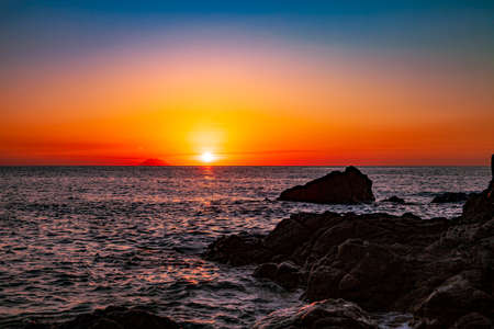 Red sunset over the sea. Beautiful sunset. Tyrrhenian Sea sunset in Calabria, Italy.の写真素材