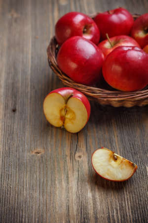 Ripe red apple on old wooden boardの写真素材
