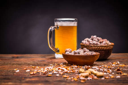 Beer and roasted peanuts with space for textの写真素材