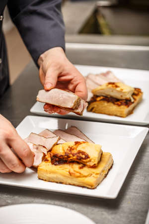 Chef making a lunch dish in restaurant kitchenの写真素材