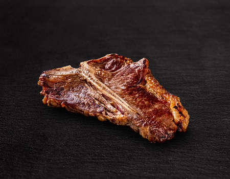 Argentinian beef T-bone steak on black backgroundの写真素材