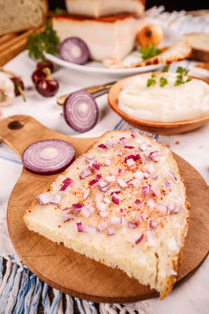 Bread slice with lard on wooden chopping boardの写真素材