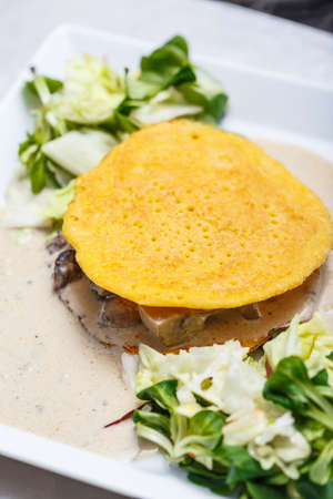 Delicious vegetarian meal with mushrooms sauce, lettuce and egg pancakeの写真素材