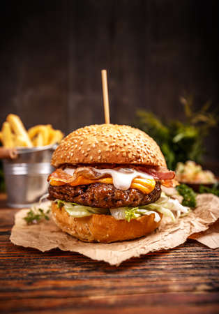 Delicious hamburger served on vintage wooden backgroundの写真素材