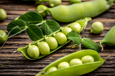 Young fresh pods of green peas on wooden backgroundの写真素材