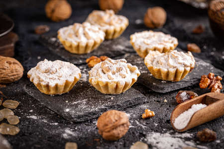 Composition of homemade sweet mini tartlets on black slateの写真素材